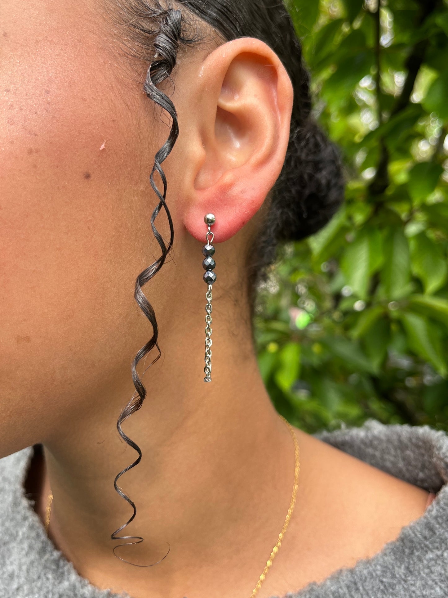 Boucles d'oreille MALIA, de couleur argent avec pierre de Térahertz, portées.