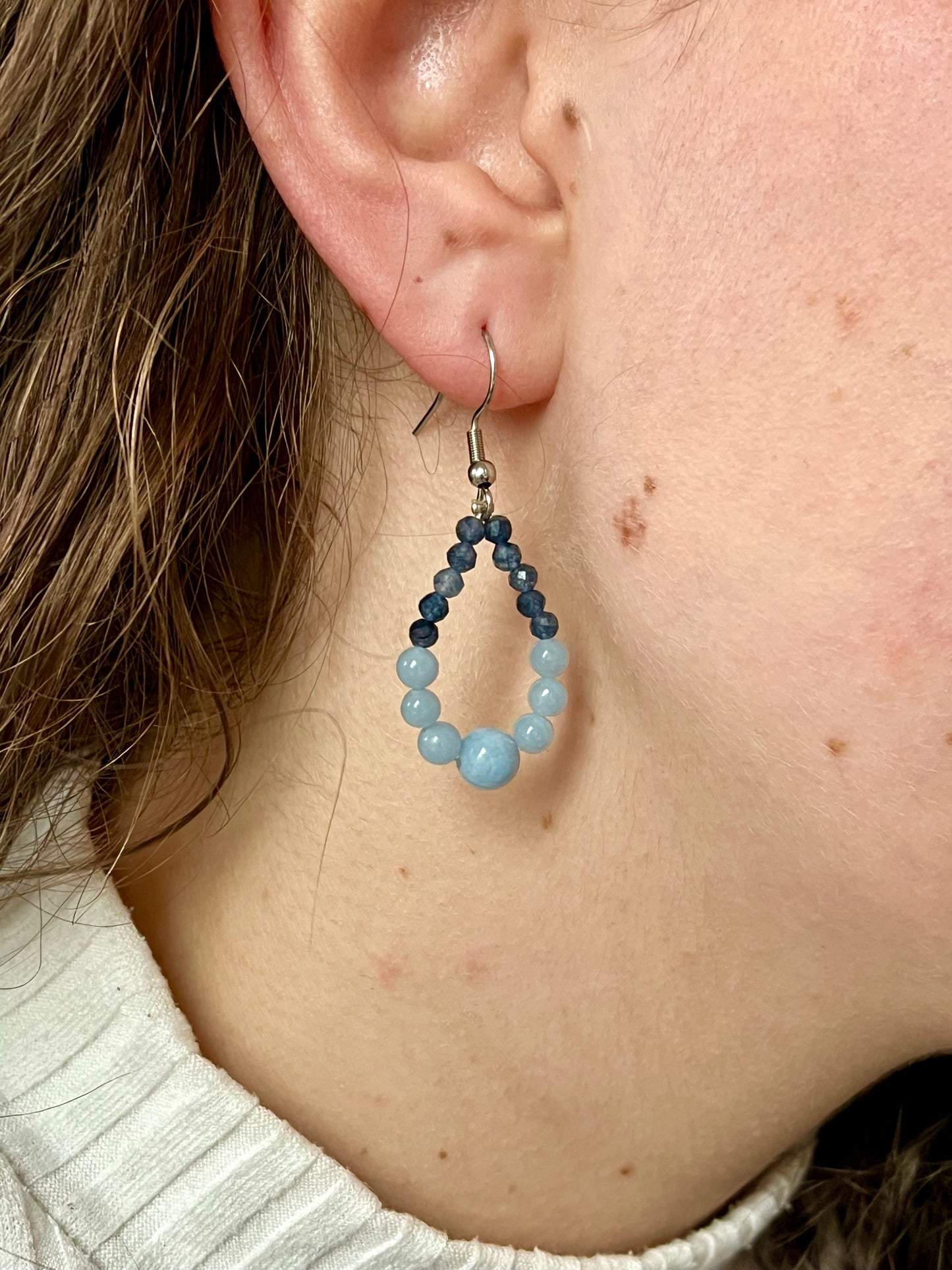 Boucles d'oreille SIMONA, avec pierres d'Angélite et de Saphir, portées.