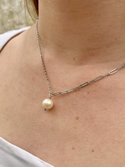 Collier ANGÈLE, de couleur argent avec Perle de Culture, porté sur un haut blanc.