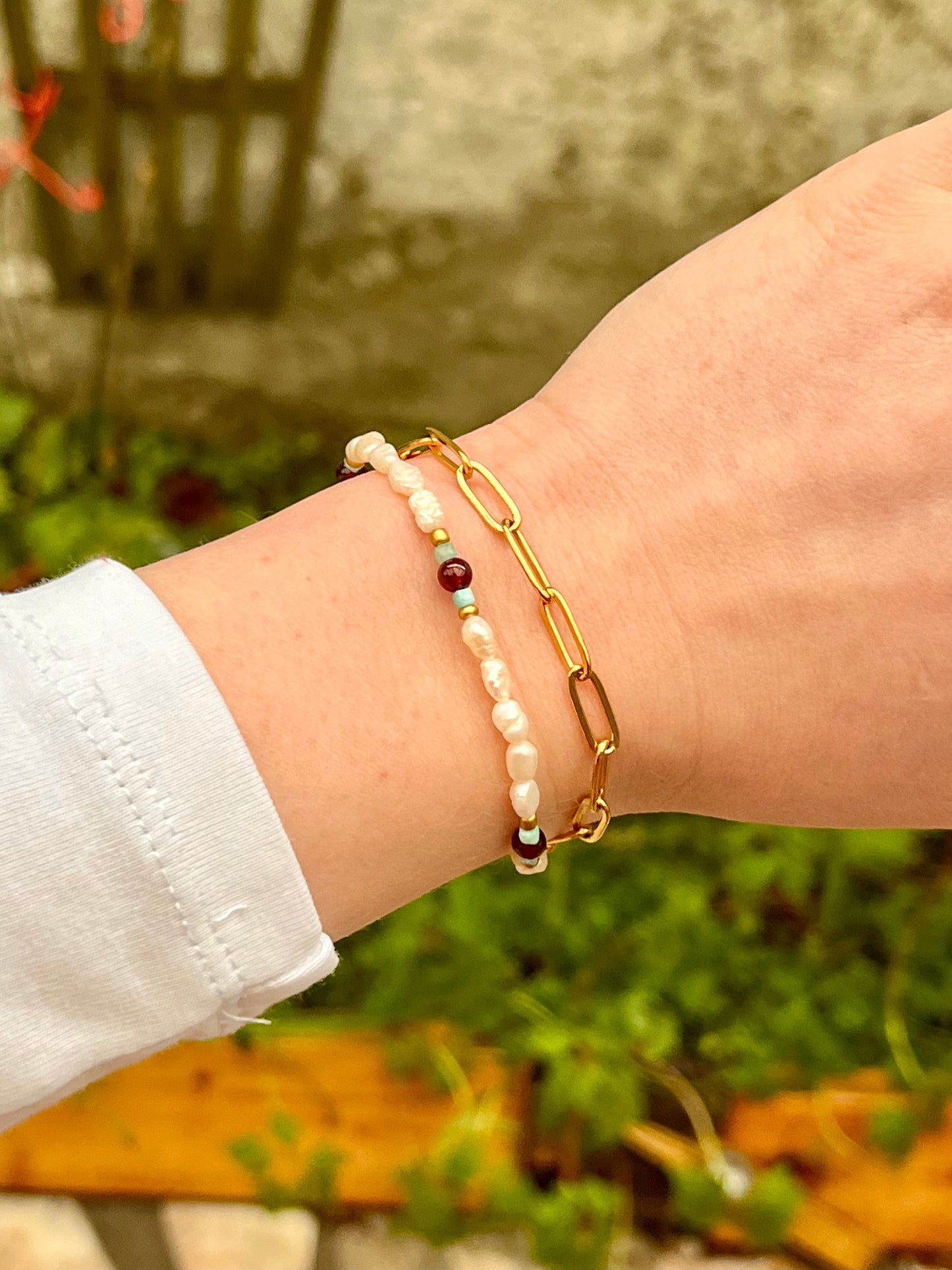 Bracelet ARIANA, avec pierre d'Amazonite, de Grenat et Perle de Culture, porté sur un poignet de femme.