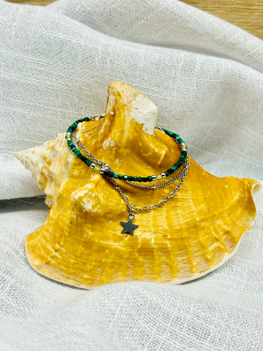 Bracelet STELLA, avec pierre de Malachite et Péridot, exposé sur un coquillage.